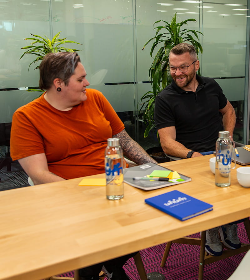 Group of Unum employees sitting at a table during a meeting
