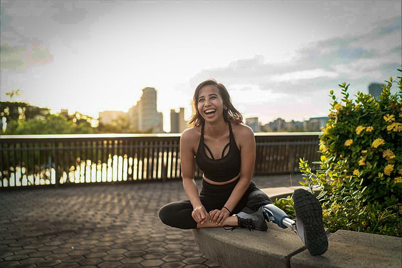 Person with a prosthetic leg stretching before a run